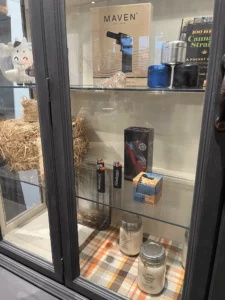 Close-up of cannabis product display at The Farmhouse with artisan-crafted shelves