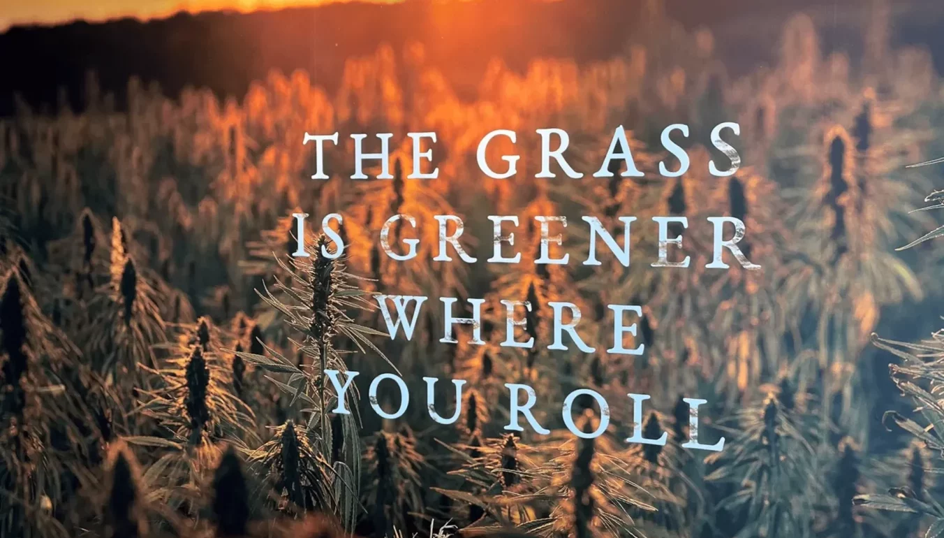 Wall art saying The Grass Is Greener Where You Roll in Port Credit inside The Farmhouse Weed Store and cannabis dispensary for Mississauga.
