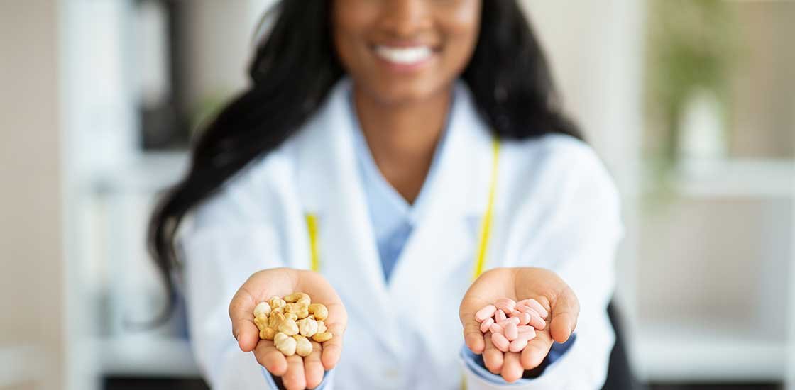 nutritionist holding cbd and thc edible gummies. Burlington weed dispensary near Appleby and The Orchard.