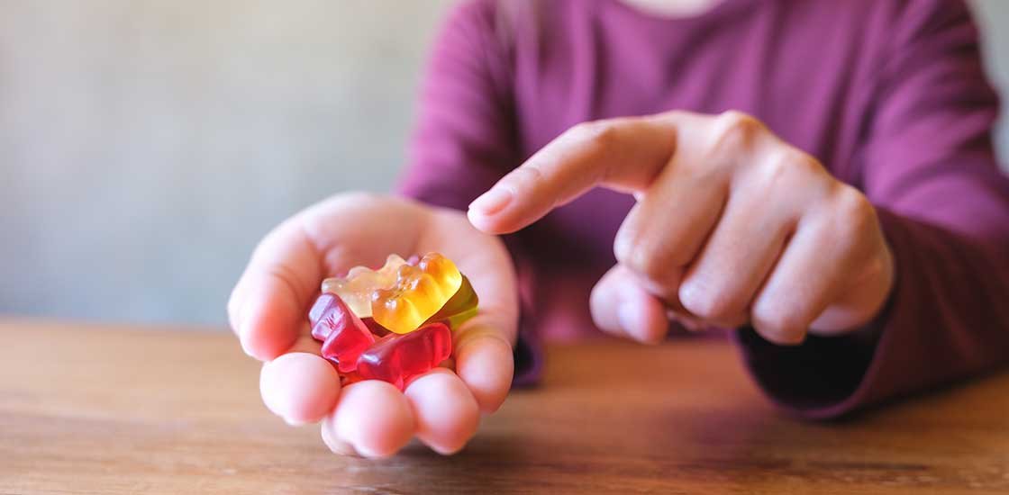 woman holding cbd and thc gummies Burlington cannabis store and Mississauga weed dispensary.