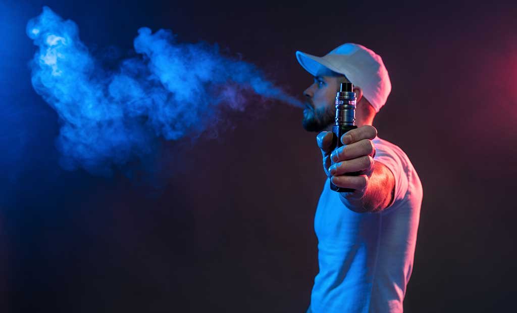 man using a 510 thread vape in Burlington. Dispensary near me.